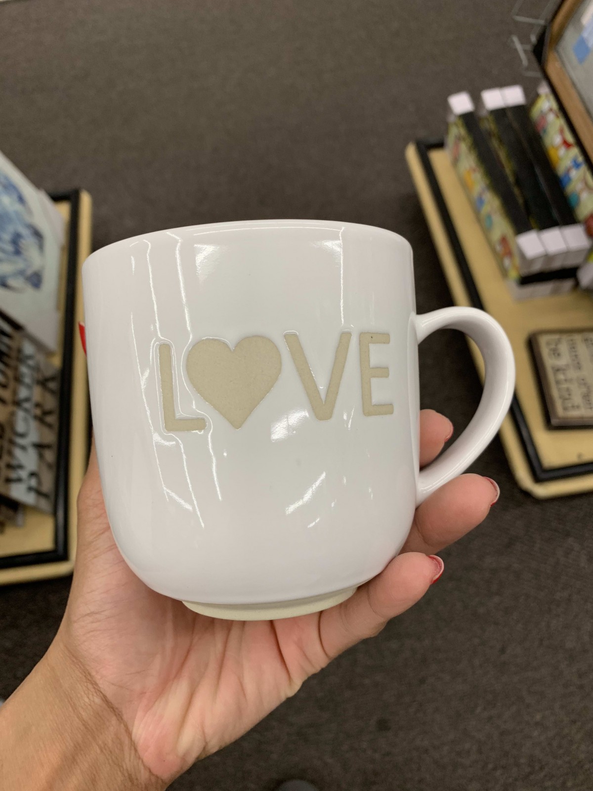 A white mug with a heart symbol replacing the 'O' in the word 'LOVE'.