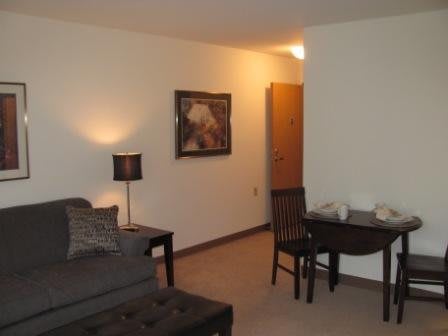 Cozy living room with a sofa, table, and wall art.