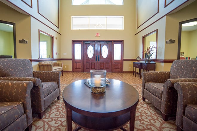 A warmly lit lobby with comfortable seating and elegant decor.