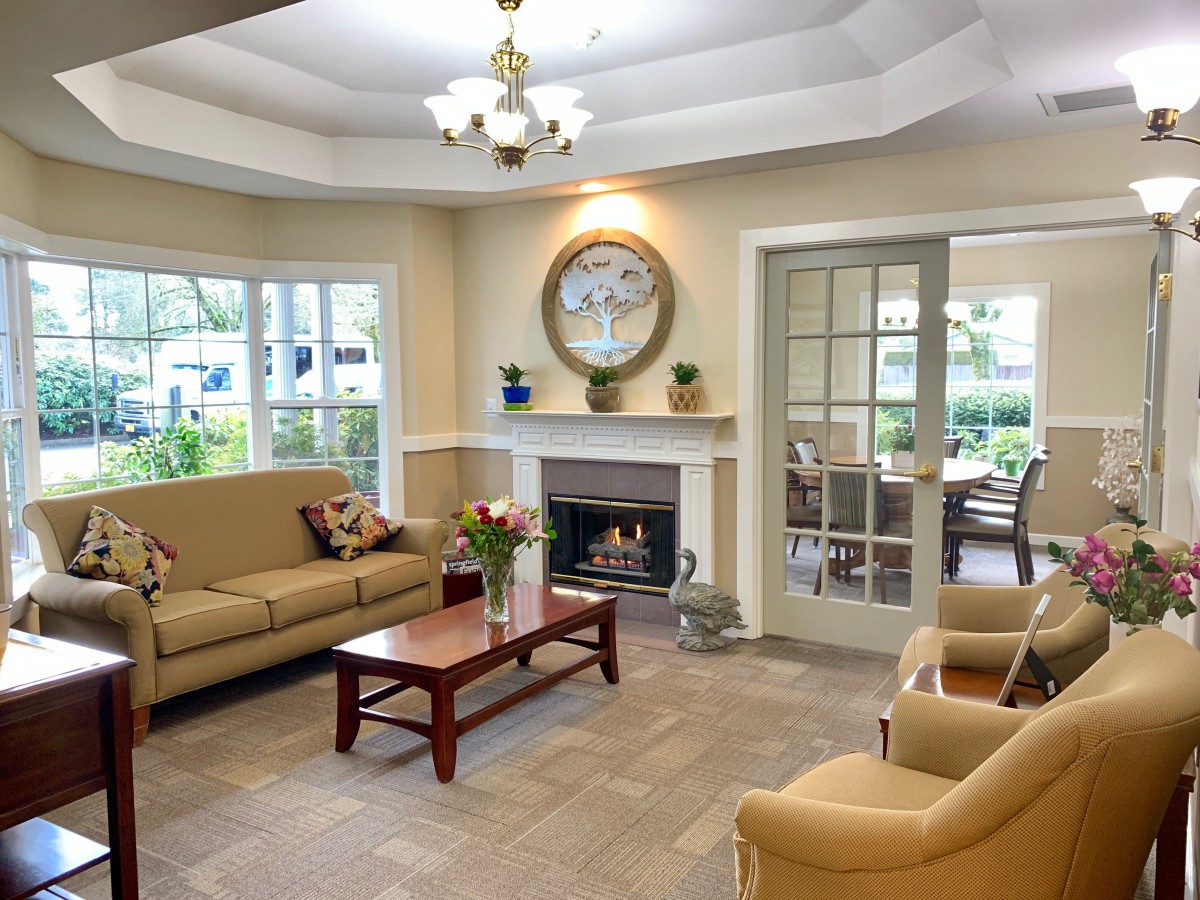 A cozy living room with comfortable seating, a fireplace, and elegant decor.