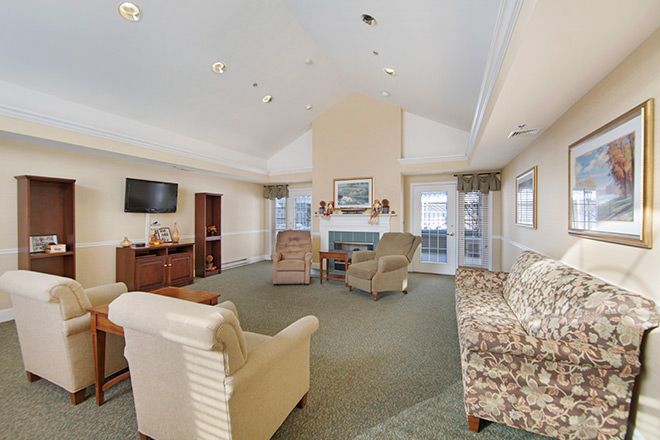 A cozy living room with comfortable seating, a fireplace, and a television.