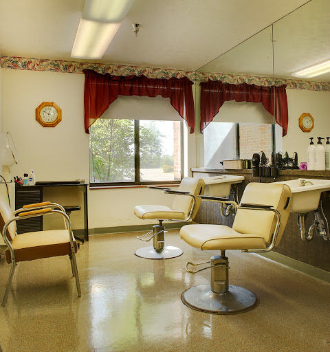 A cozy barbershop interior featuring two stylish chairs and a welcoming atmosphere.