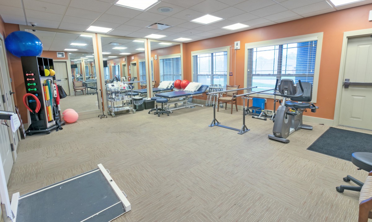 A spacious gym with exercise equipment and workout areas.