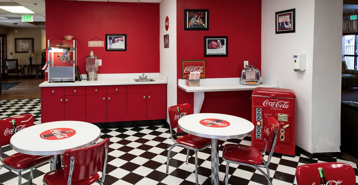 A retro-style diner with a red and white color theme and checkered flooring.