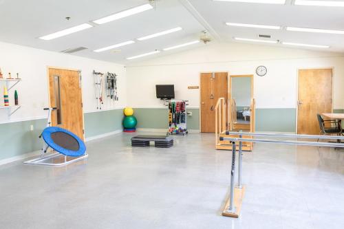 A well-equipped physical therapy room featuring various rehabilitation tools and exercise equipment.