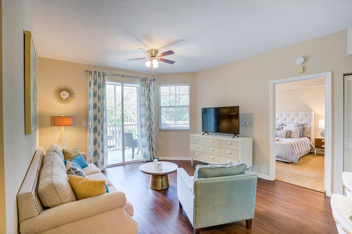 A cozy living room featuring modern furniture, a television, and tasteful decor.
