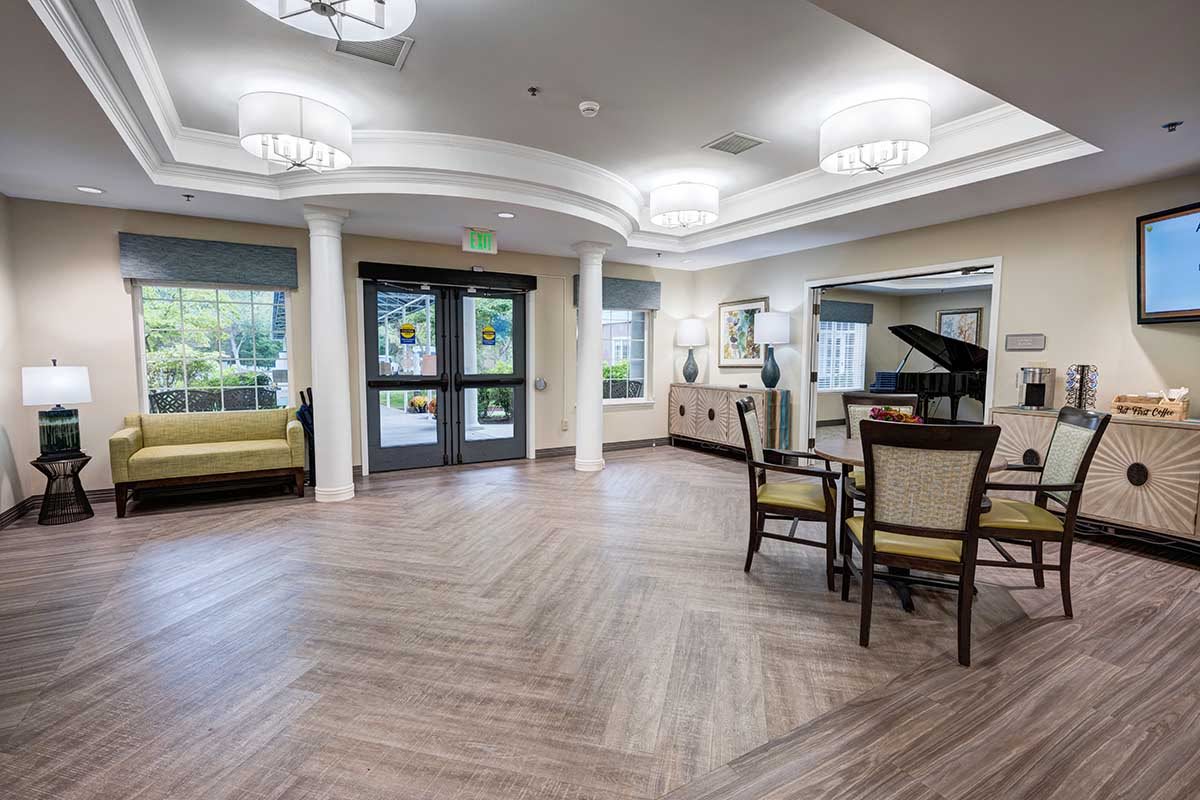 A modern, spacious lobby featuring a piano and comfortable seating.