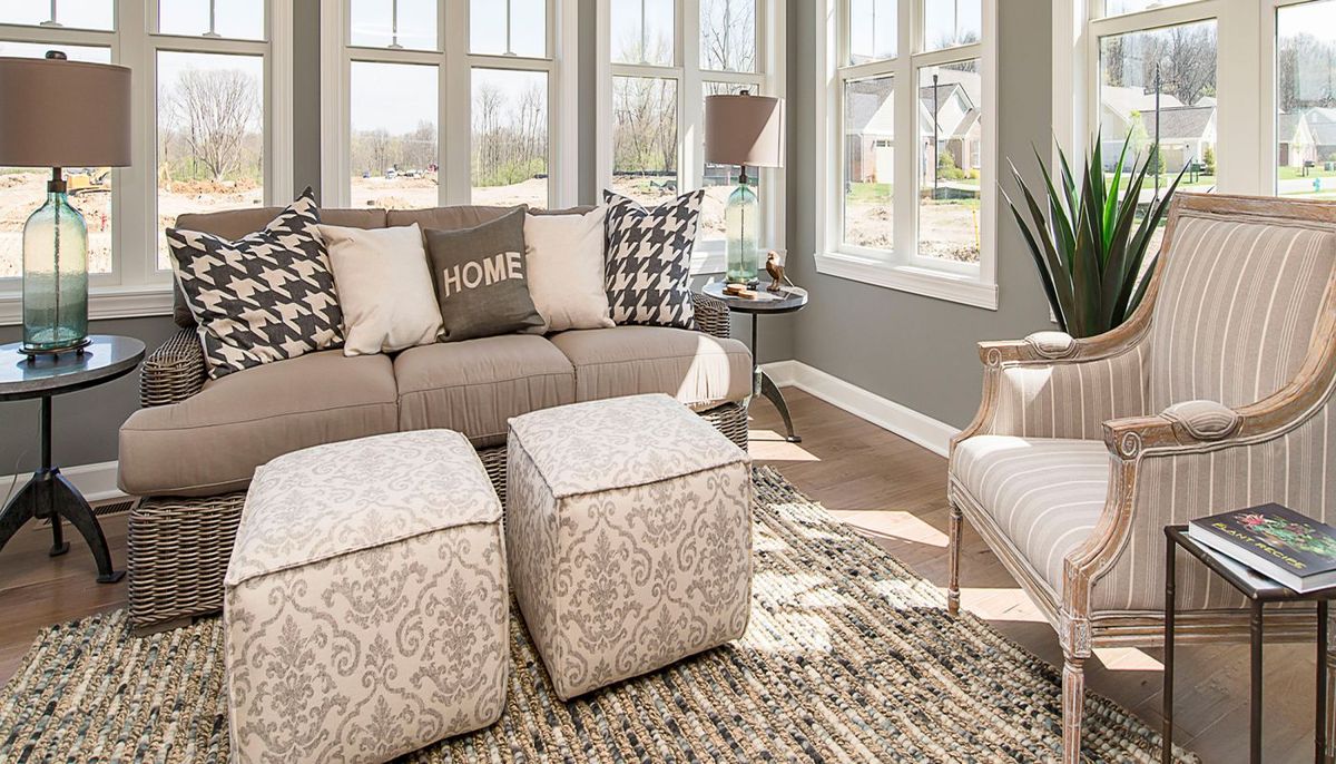 A cozy and bright living room with modern furniture and large windows.