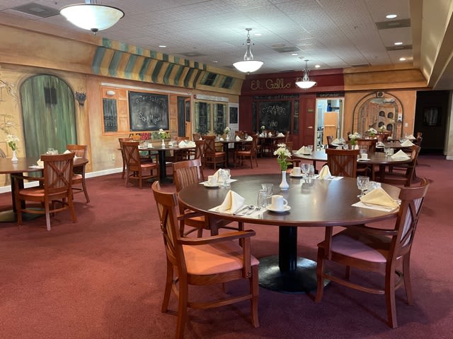 A well-decorated restaurant dining room with neatly arranged tables and chairs.