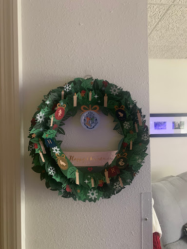 A beautifully decorated holiday wreath hanging on a wall.