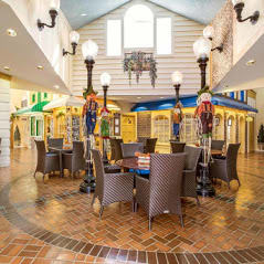 A charming indoor marketplace setting with tables and decorative lampposts.