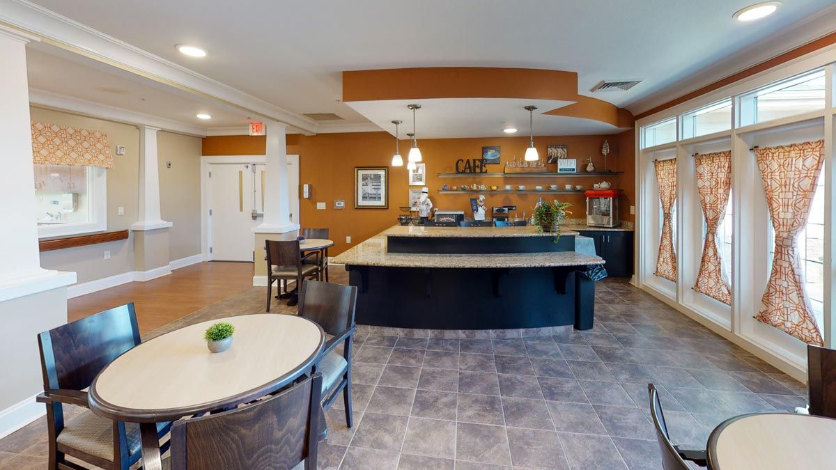 A modern kitchen with a central countertop and seating area.