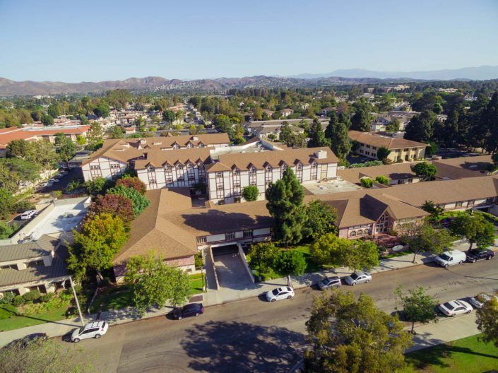 Aerial view of a suburban residential neighborhood with trees and houses.