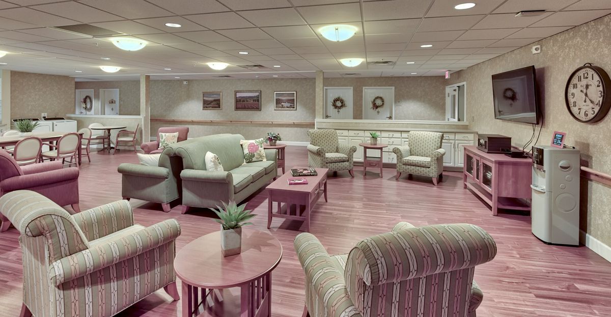 A cozy lounge area featuring multiple sofas, chairs, and coffee tables arranged in an inviting setting.