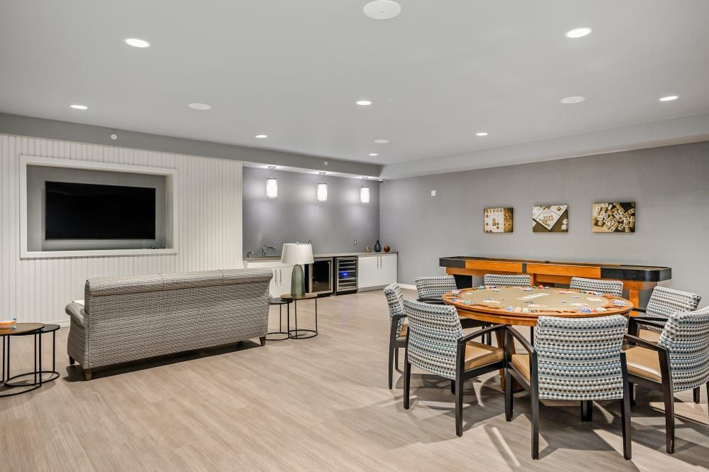 A modern living room with a comfortable seating area and a large dining table.