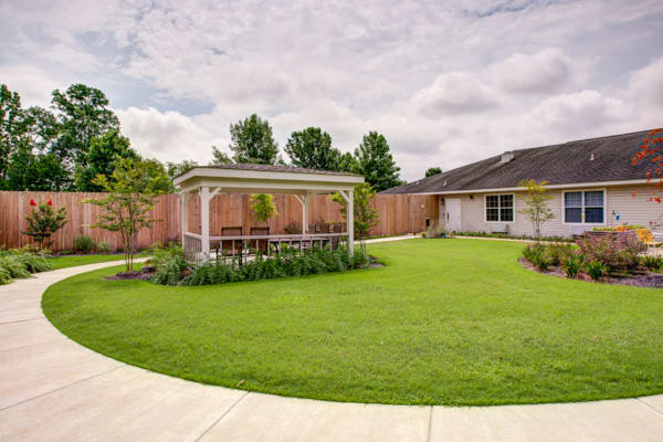 A well-maintained backyard featuring a lush lawn and a charming gazebo.