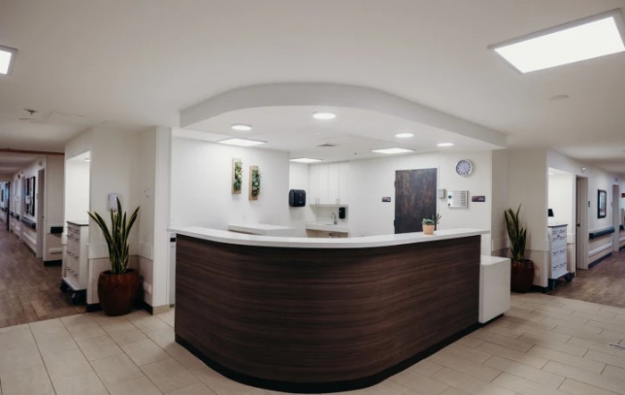 A modern office reception area with a sleek desk and minimalist design.
