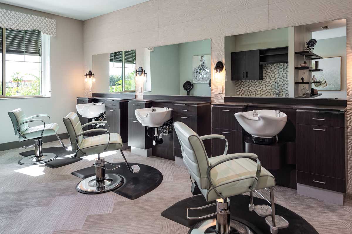 A modern salon interior with styling chairs and hair wash stations.