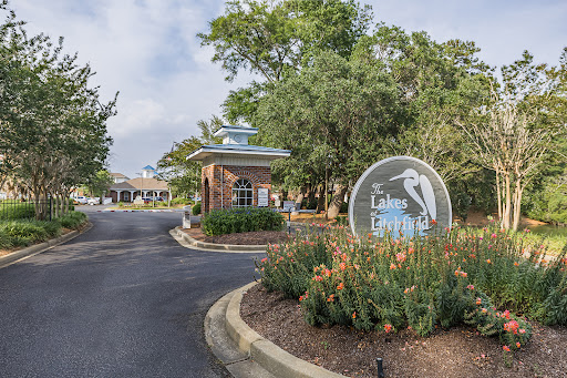 The welcoming entrance to a community with well-maintained landscaping and clear signage.