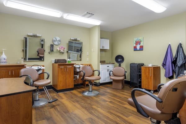 A well-organized hair salon with styling chairs and mirrors.