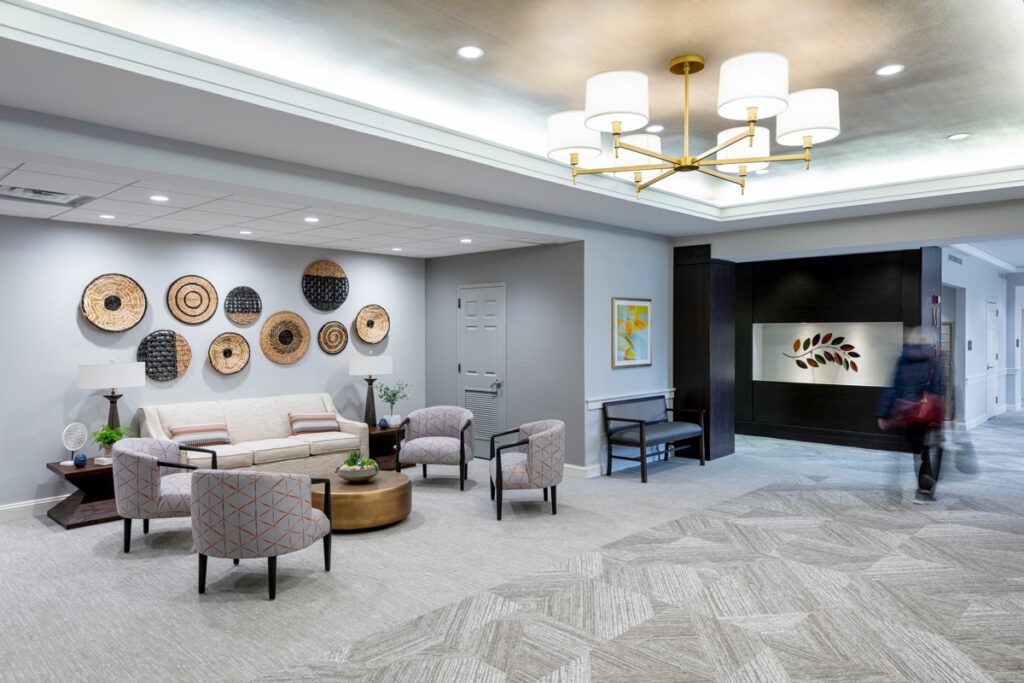 A modern lobby featuring stylish furniture, decorative wall art, and elegant lighting.
