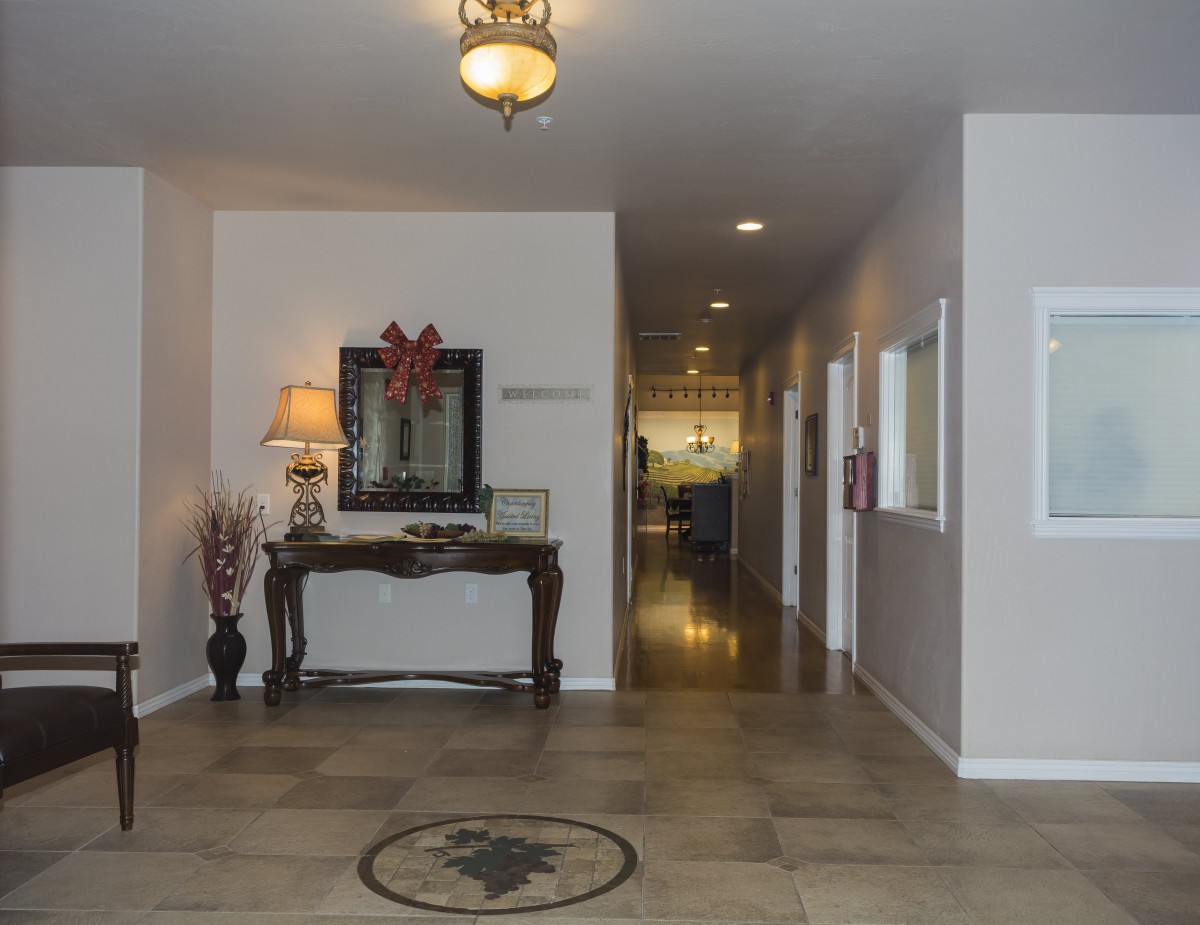 A well-decorated hallway with a table and mirror, featuring modern lighting.