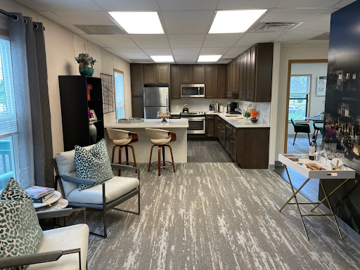 A modern open-concept kitchen and living area featuring stylish furniture and contemporary appliances.