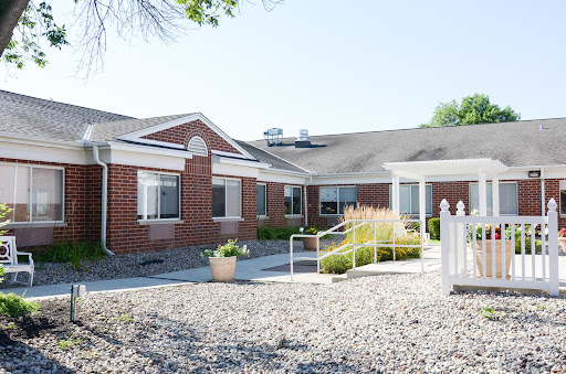 A welcoming single-story brick residential building with well-maintained landscaping.
