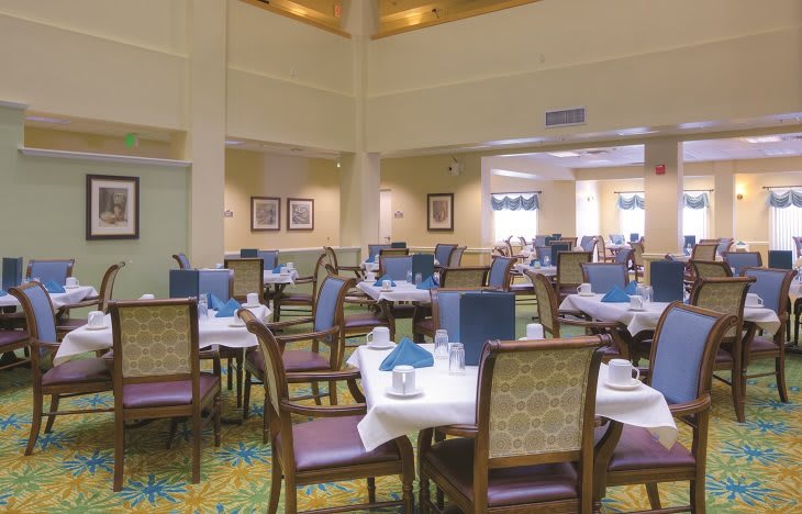 Elegant dining area with neatly set tables and comfortable chairs.