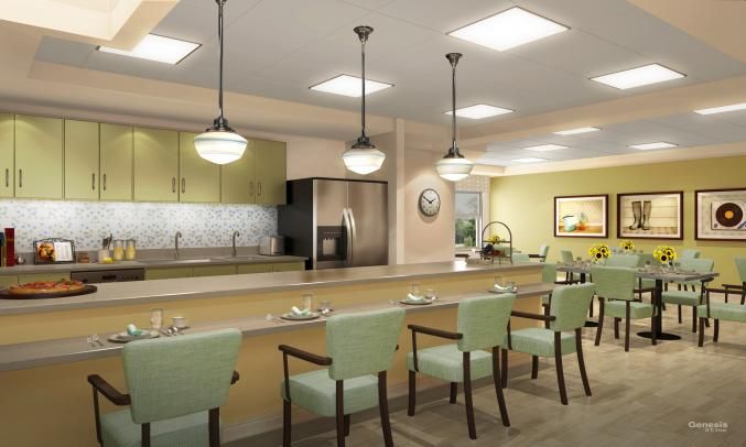 A modern kitchen interior with a long counter and stylish pendant lighting.