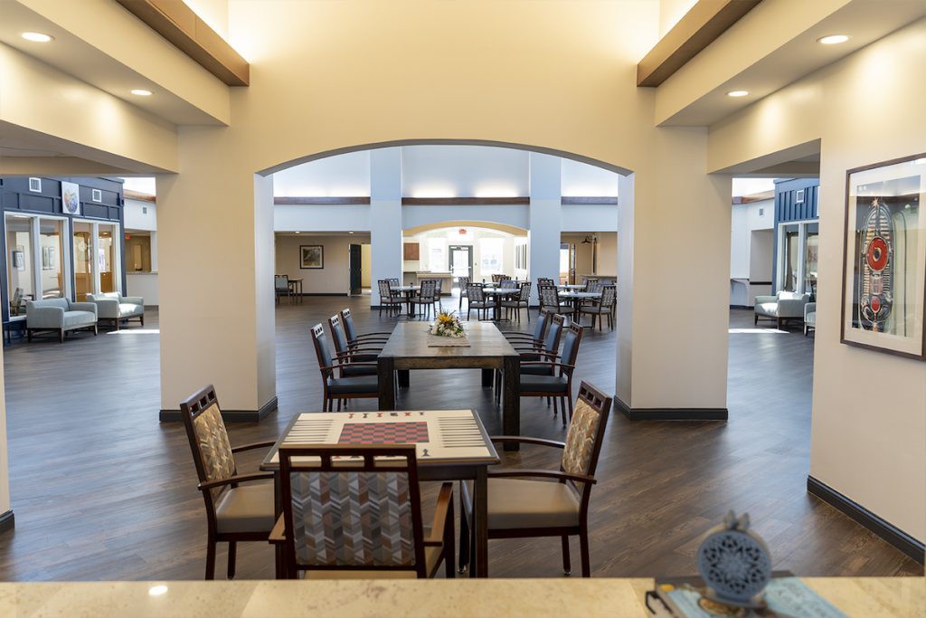 A spacious dining area with neatly arranged tables and chairs, showcasing modern interior design.