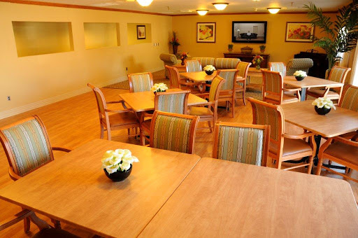A cozy lounge area featuring wooden tables and chairs, perfect for gatherings or relaxation.