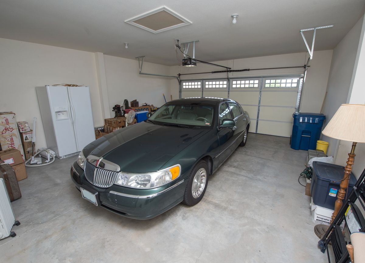 A sedan parked inside a residential garage.