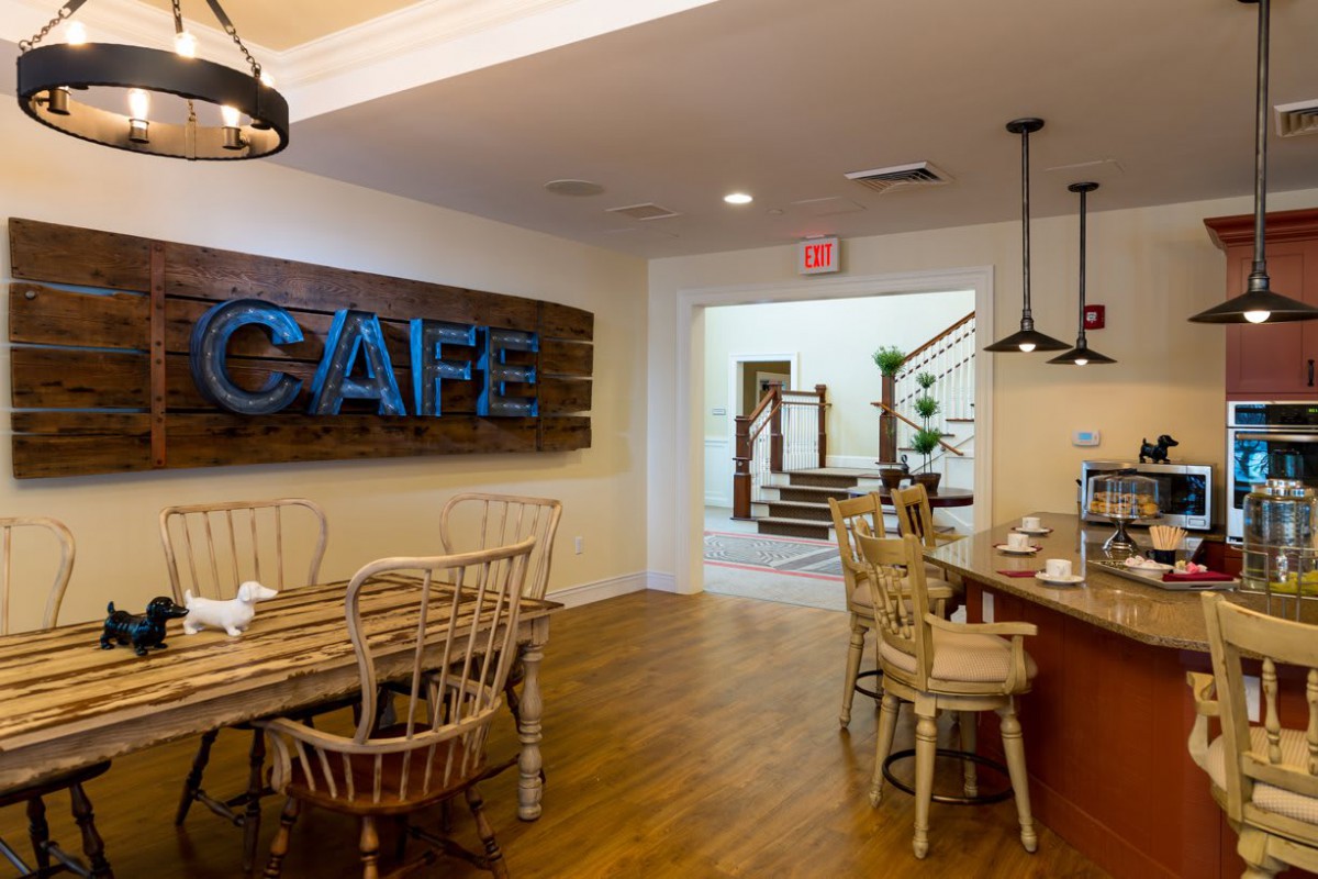 Modern cafe interior with wooden furniture and stylish lighting.