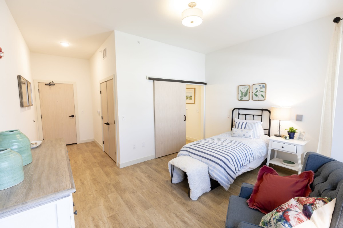 A modern, minimalist bedroom with a single bed and stylish decor.