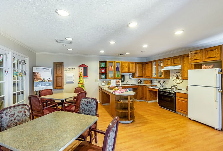Modern kitchen and dining area with wooden cabinetry and an open layout.