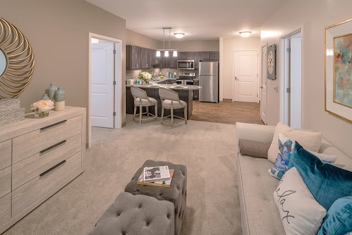 A modern apartment living space featuring an open layout with a cozy seating area and a stylish kitchen.
