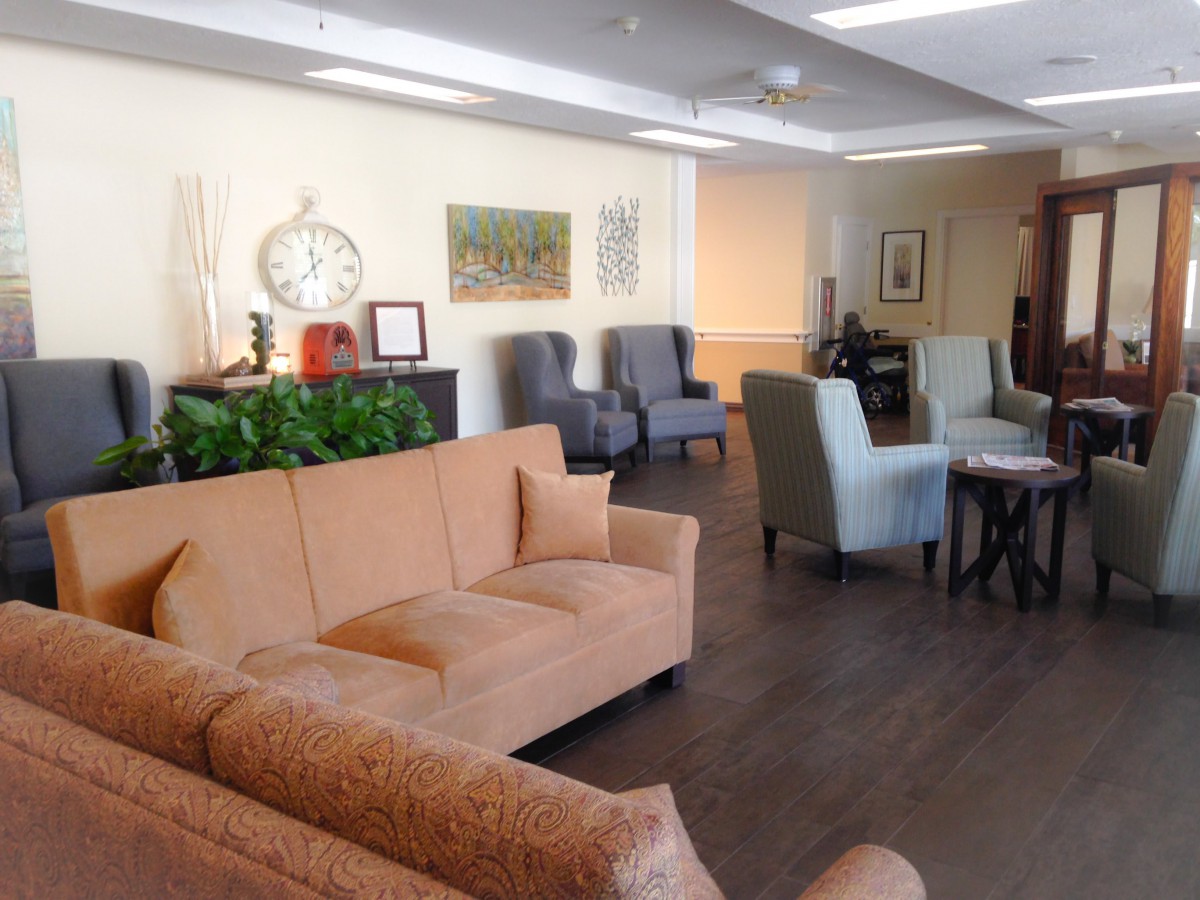 A cozy lounge area featuring sofas and chairs with warm lighting.