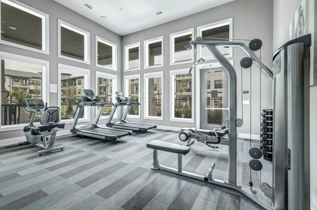 A modern gym featuring treadmills and exercise equipment in a well-lit space.