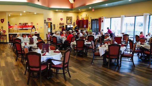 A bustling dining room filled with people enjoying a meal together, showcasing a warm and inviting atmosphere.