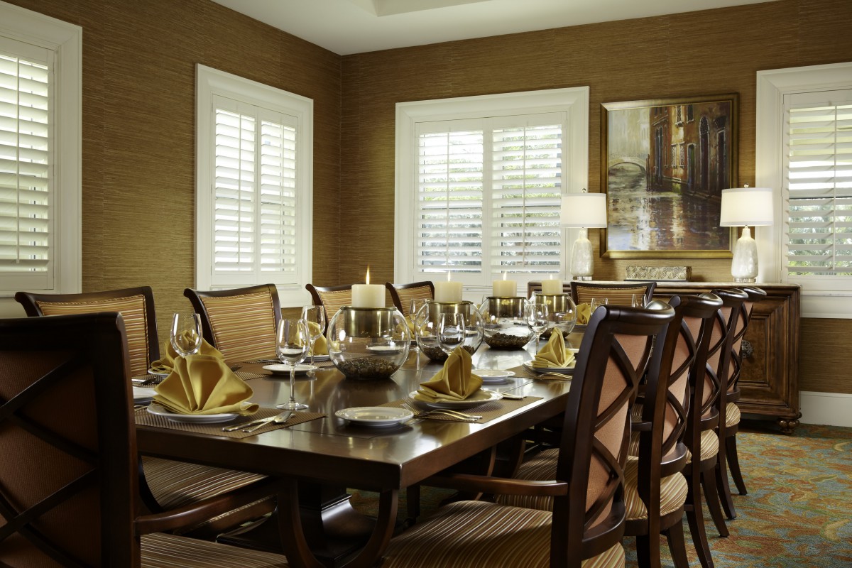 A beautifully set dining room table with elegant decor and comfortable seating.