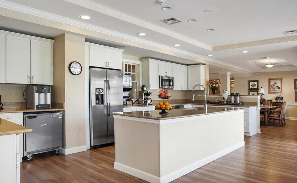 A modern kitchen with a large island and stainless steel appliances.