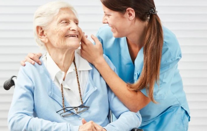 A caregiver interacting warmly with an elderly woman, highlighting compassionate elderly care.