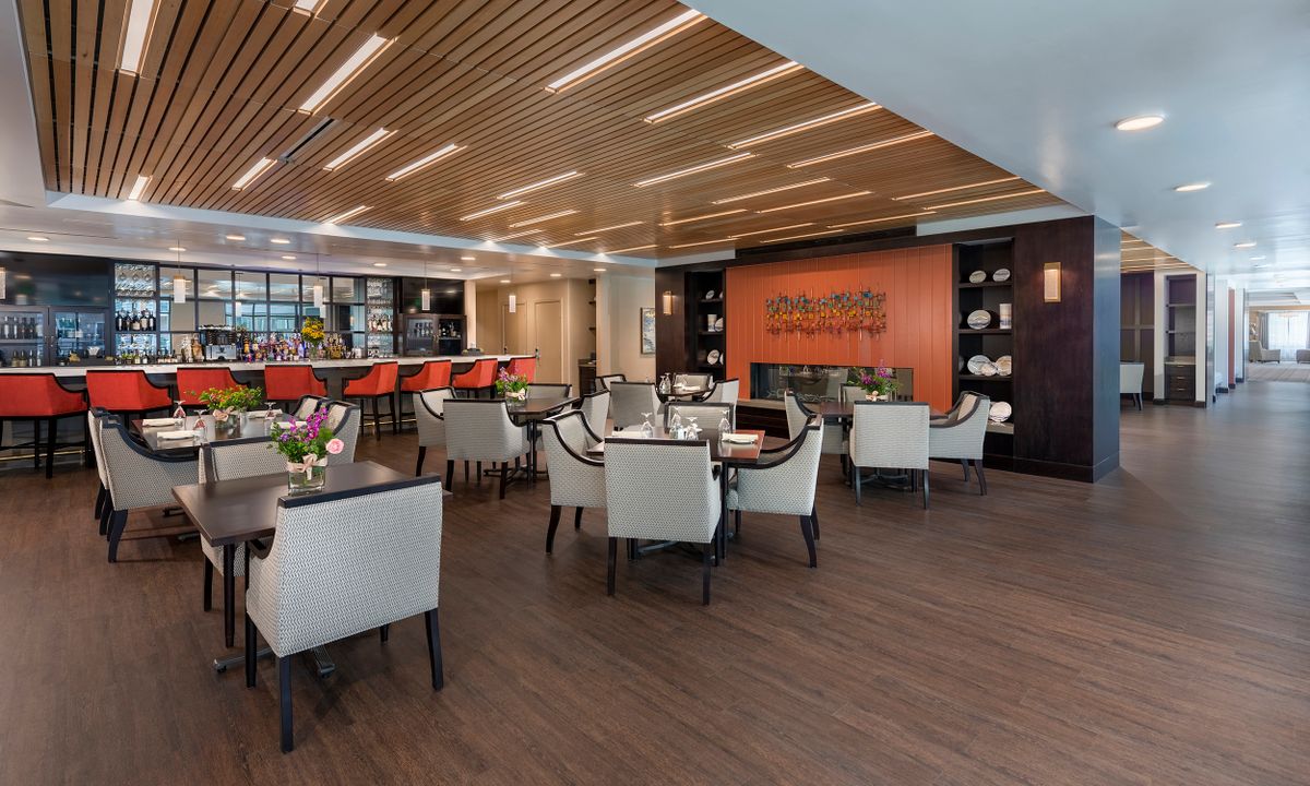 A modern restaurant interior with a stylish dining and bar setup.