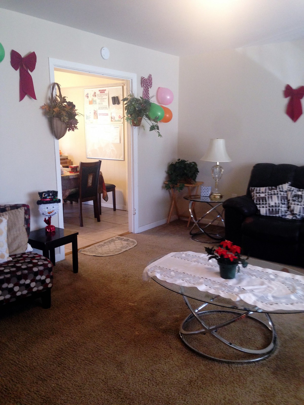 A cozy living room decorated with bows and plants.