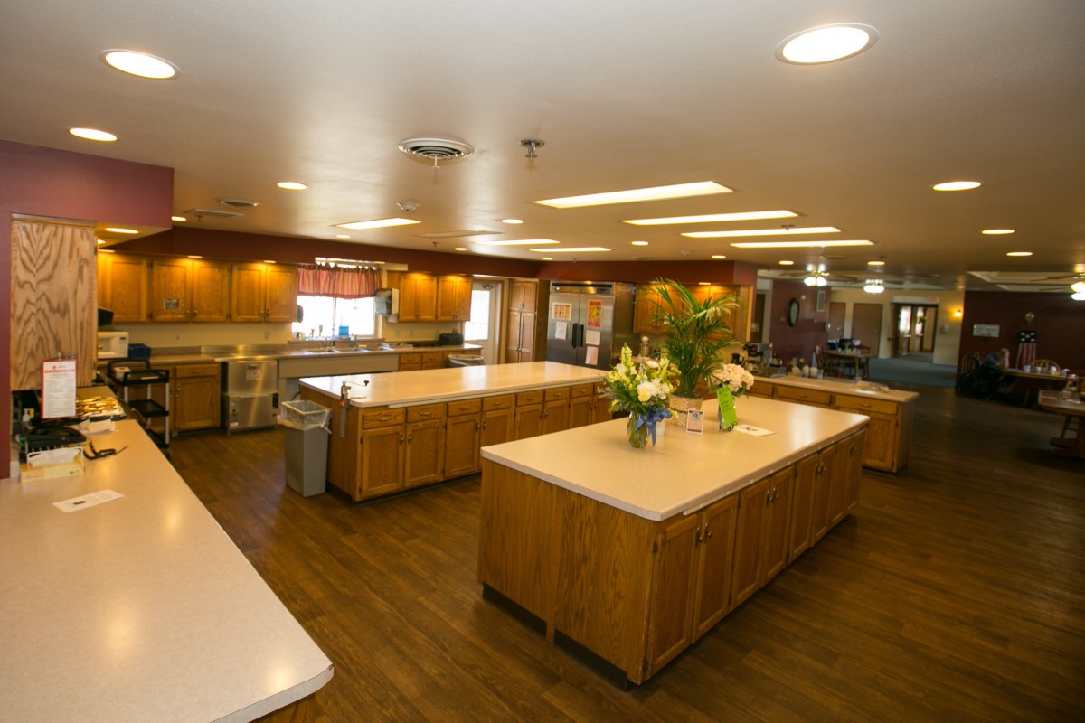 A spacious kitchen interior with multiple islands and wooden cabinetry.