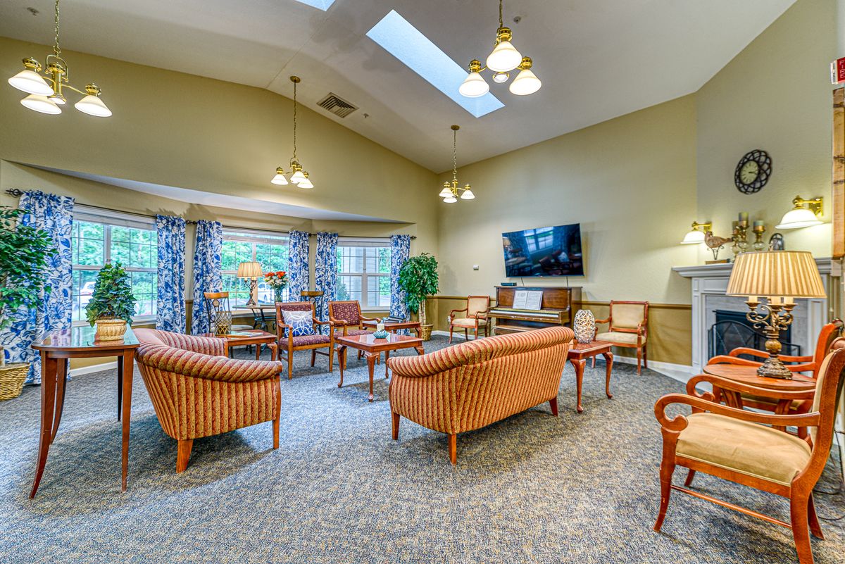 A cozy living room with comfortable seating and a mounted television.
