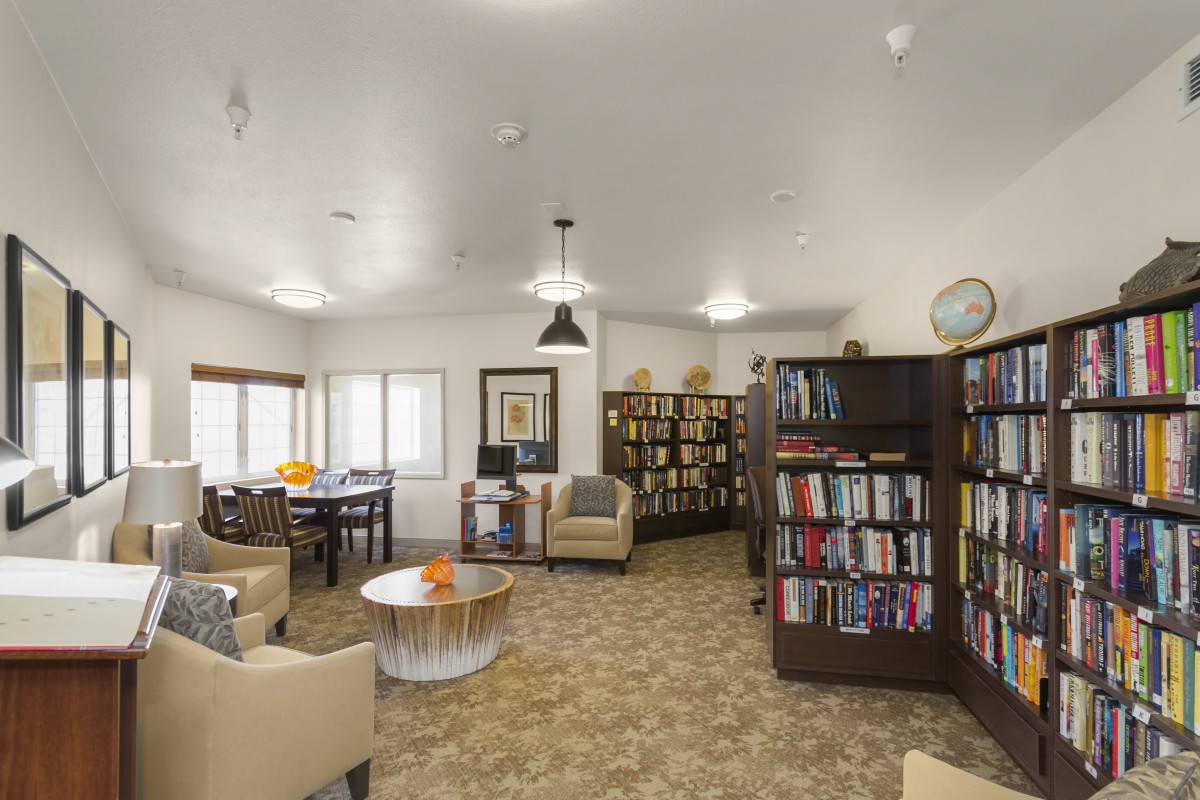 A cozy library with bookshelves and a comfortable seating area.