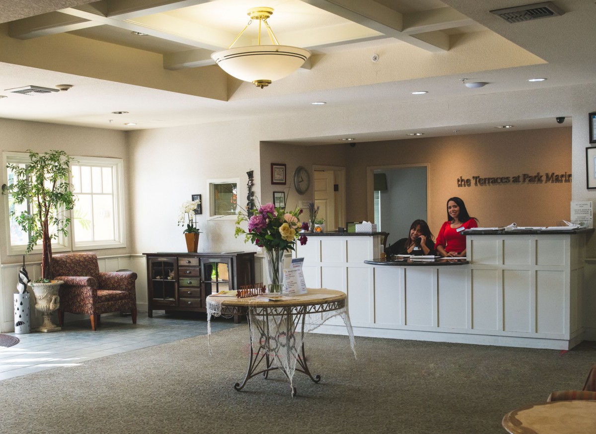 A welcoming reception area with a desk and flowers on display.