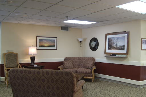 A cozy living room featuring comfortable seating and decorative wall art.